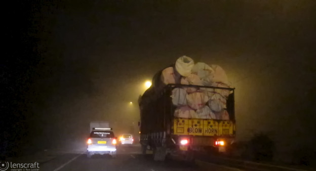 traffic through the fog / near sikri, india